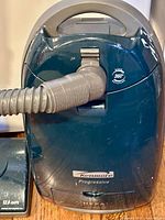 Kenmore Progressive canister vacuum body showing hose connection, 360° swivel marking, HEPA badge, visible surface scratches