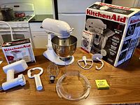 Complete lot showing mixer, bowl, attachments, grinder parts and original boxes