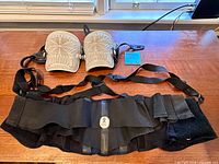 Overall view: pair knee pads above black lumbar support belt with suspenders