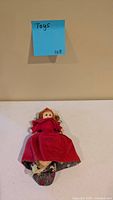 Full view of reversible Little Red Riding Hood cloth doll on tabletop