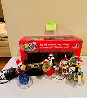 Four animated Looney Tunes musical figurines, power adapter, original Bugs Bunny Brass Band box