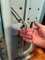 Close-up of ironing board underside hinge and mint color