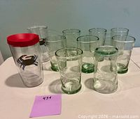 Group of tumblers showing quantity, glass styles, etched designs, crab tumbler, and lid