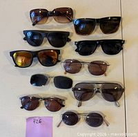 All 10 pairs of assorted sunglasses laid out for overview