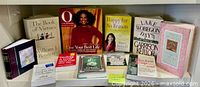 Shelf showing 13 assorted English books including noted titles