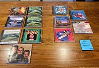 Overview of all 12 jewel-cased CDs laid out on table