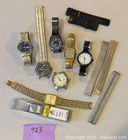 All wristwatches and watch bands arranged on tabletop for overview