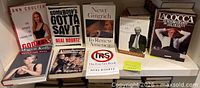 Shelf showing nine political hardcover books
