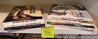 Six Calvin and Hobbes softcover books stacked on shelf with titles visible on spines