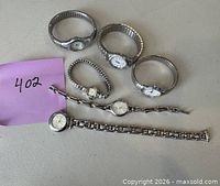 All six silver-tone women’s wristwatches displayed on tabletop