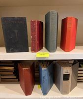 Front and spine views of all seven cloth-bound hardcover books