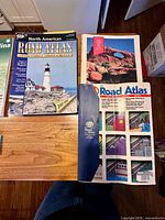 AAA North American Road Atlas, AAA loose-leaf atlas binder and part of AAA Road Atlas paperback visible