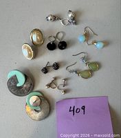 Group shot of all eight earring pairs laid out on table
