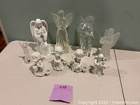 group shot of all nine porcelain and glass angel figurines displayed on table