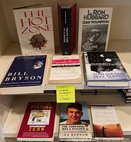 All nine books arranged on shelving, spines and covers visible