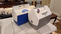 Two Igloo Little Playmate personal coolers, blue/white and gray/white versions