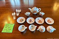 Full layout of porcelain teddy bear tea set with spoons