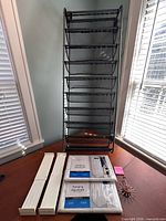 Overall lot showing mesh organizer, two sealed wardrobe covers, plastic brackets, hook spinner