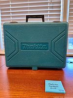 Closed Makita teal hard case showing exterior and logo