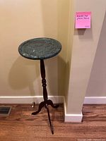 Full view of plant stand front with marble top and wood base