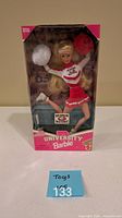 Front view of boxed University Barbie Georgia cheerleader doll with pom-poms visible