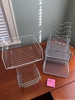 Group shot of all metal mesh desk organizers and wire baskets on tabletop