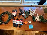 All cords and adapters laid out on table, showing colours, lengths, plug types and quantity