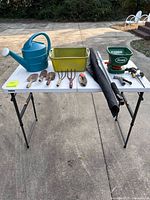 Full lot on table showing all garden tools and accessories