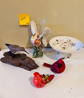 Group shot of all items: swan vase, cake stand, wood bird, two resin birds