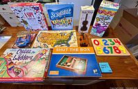 Overall view of board games, puzzles, toy cars and toy violin arranged on tabletop