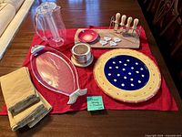 All servingware items laid out: platters, board, knives with stand, cheese markers, dipping bowl, coasters, napkins, infusion pitcher