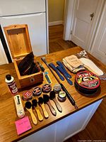 All items laid out including wooden box, brushes, daubers, shoehorns, polish tins, boot oil, cloths, insoles