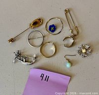 All ten jewelry pieces laid out on surface