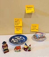 Entire lot displayed: transferware dish, Kutani cup and saucer, three miniatures, block figurine