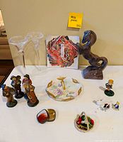 All items laid out: glass vases, horse, musician figurines, handled plate, small trinket dish, fruit basket, goose miniatures