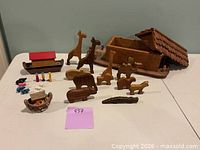 Overall view showing ark, roof, small boat and array of carved animal and human figures