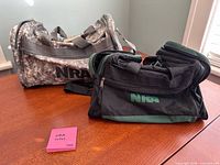 Both NRA insulated bags showing logos, colors, styles and overall condition