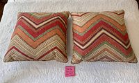 Front view of both chevron pillows on white cover