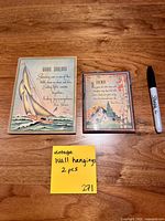 Front view showing both printed illustration plaques with marker for scale