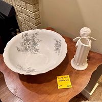 Large porcelain bowl and cherub vase/candleholder on table