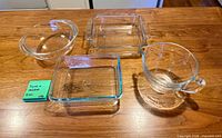 top-down view of all four clear glass pieces on wood surface
