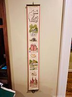 Front view of entire needlepoint hanging showing motifs and hardware