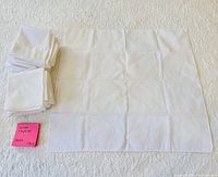 Stack of folded napkins with one unfolded to show size and fabric