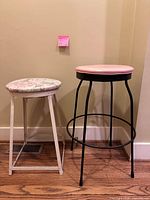 Full view of both metal stools side by side