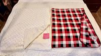 Both throw blankets laid side by side on bed