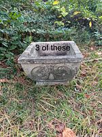 Single planter front view showing scroll design and weathered surface