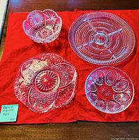 Top view of all four cut glass pieces on red cloth