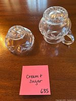Top view of creamer and sugar showing lids and pattern
