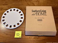 Top view of white ceramic serving plate beside original Southern Living at Home box