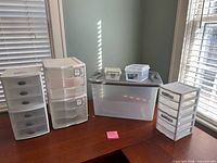All Sterilite storage pieces lined on desk